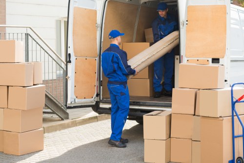 Man and van loading furniture in White City residential area