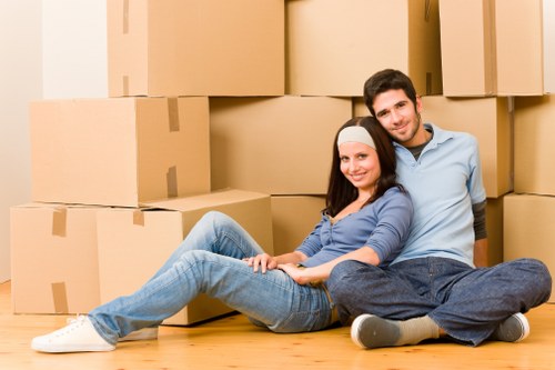 Whitecity apartment moving team navigating a narrow hallway