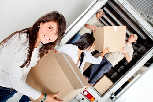 Packed boxes and furniture secured inside a moving truck in Whitecity